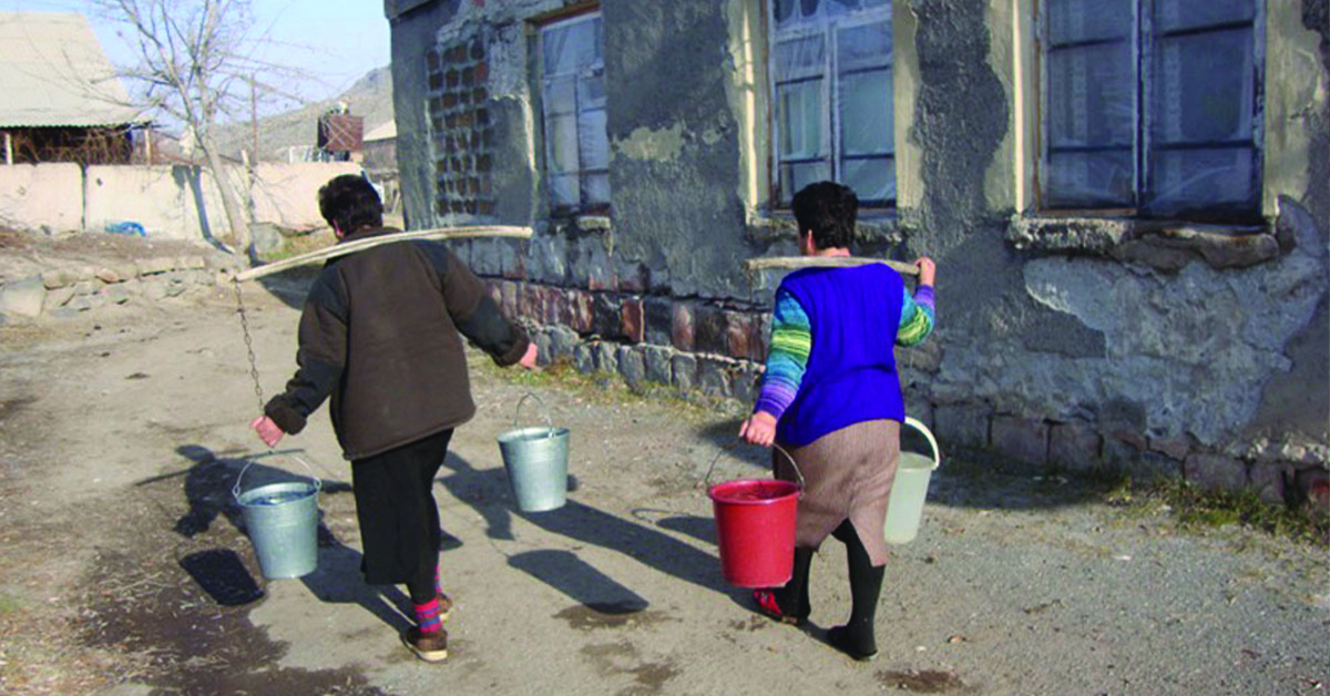 two villagers carrying buckets of water