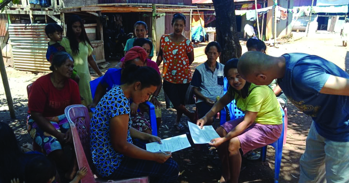 A small group of villagers listening to a TCD lesson