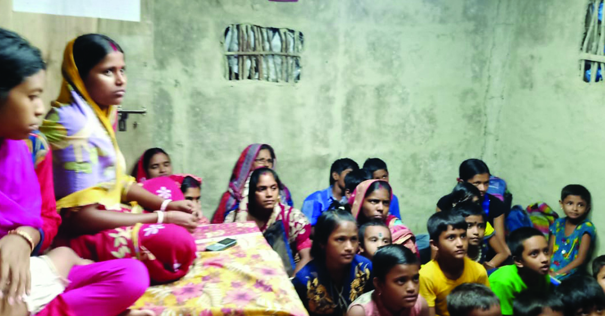 A group of Binodpur villagers listening to a meeting