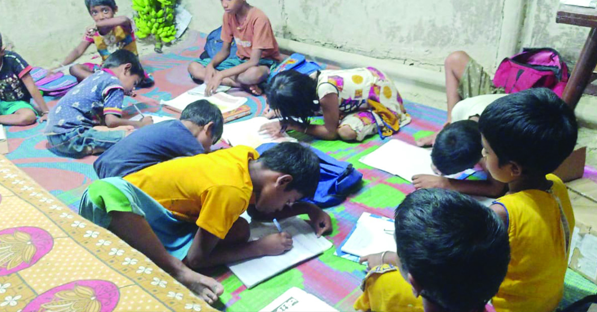 Children in the classroom learning and working on a paper assignment