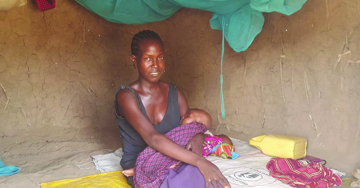 A mother in the middle of feeding her baby.