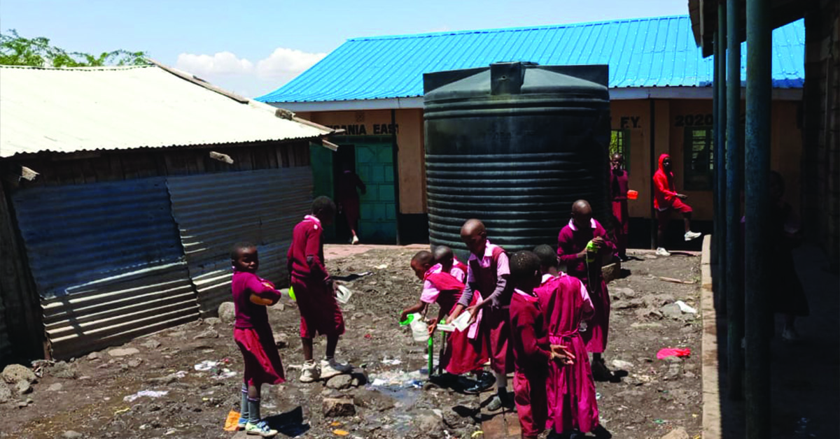 Villagers working on building a school building.