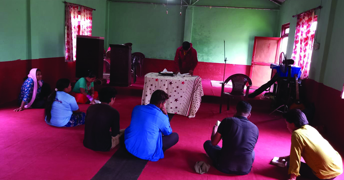 An indoor TCD meeting with a small group of villagers.