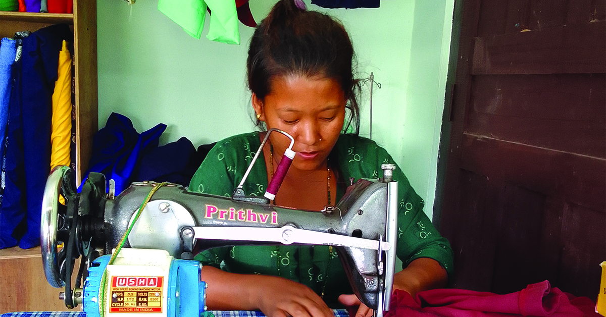 A Nepal woman using a sowing machine