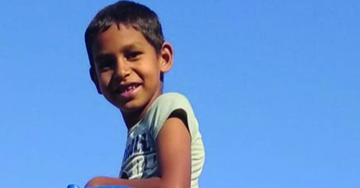 A smiling child playing on the playground