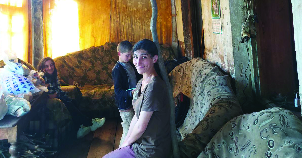An Armenian woman posing inside a house.