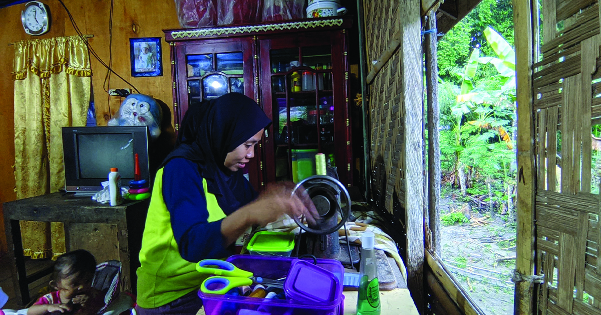 Indonesia villager, Masni, working in her household.