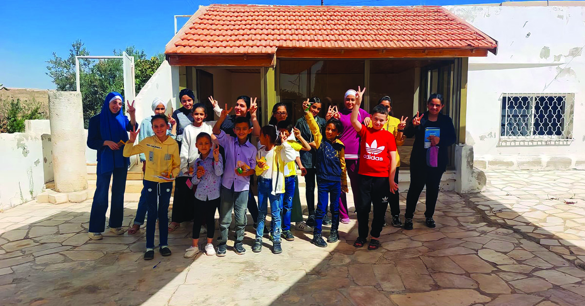 The students and teachers in front of the education building.