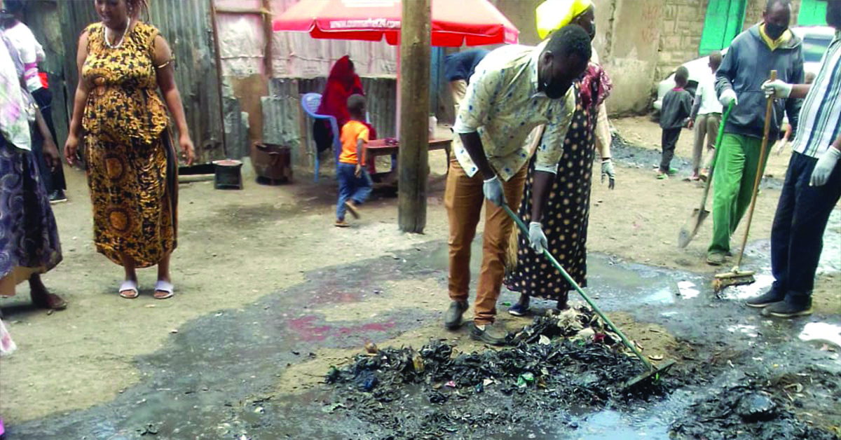 Kibera locals cleaning around the village.