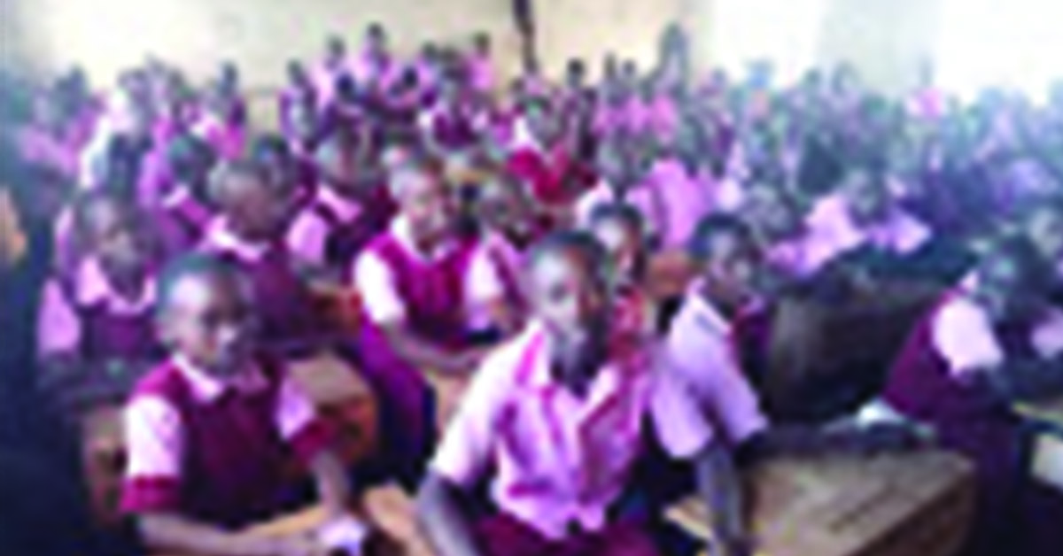 A classroom filled with students in red uniforms.