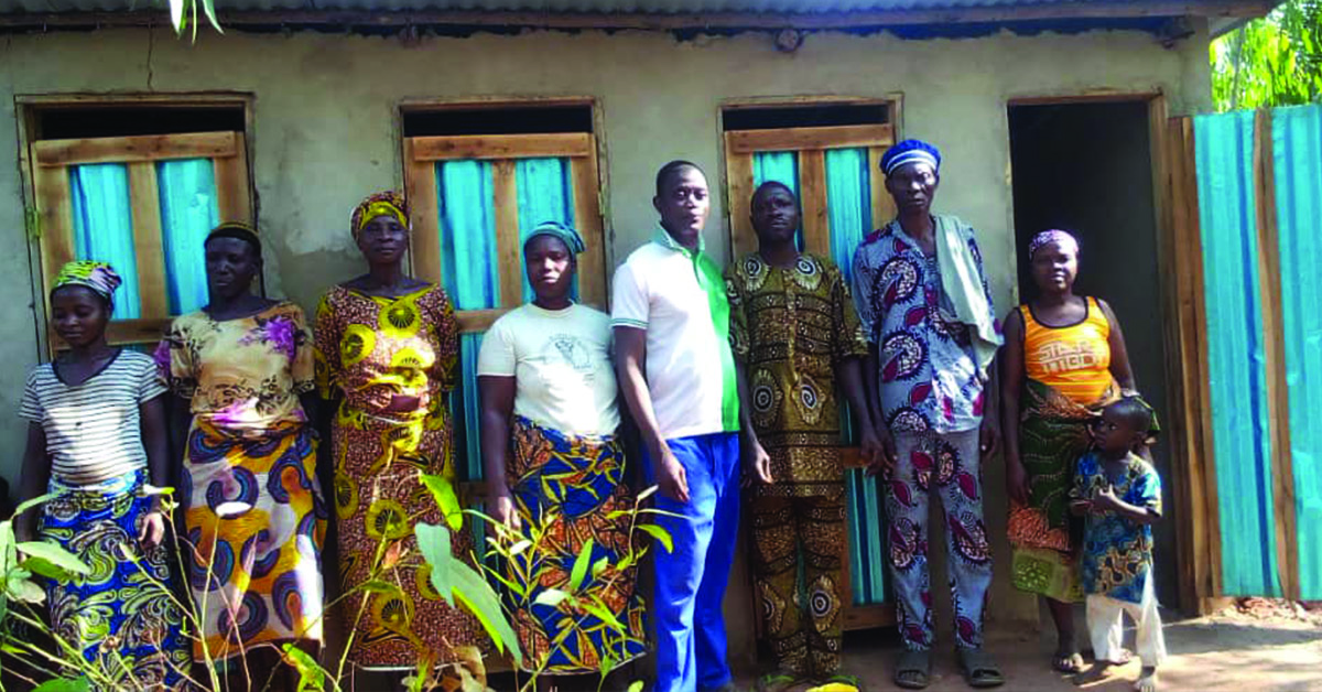 Takon Villagers standing in front of their latrines.