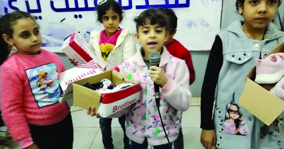 An Egyptian child, Mayville, speaking on a microphone.