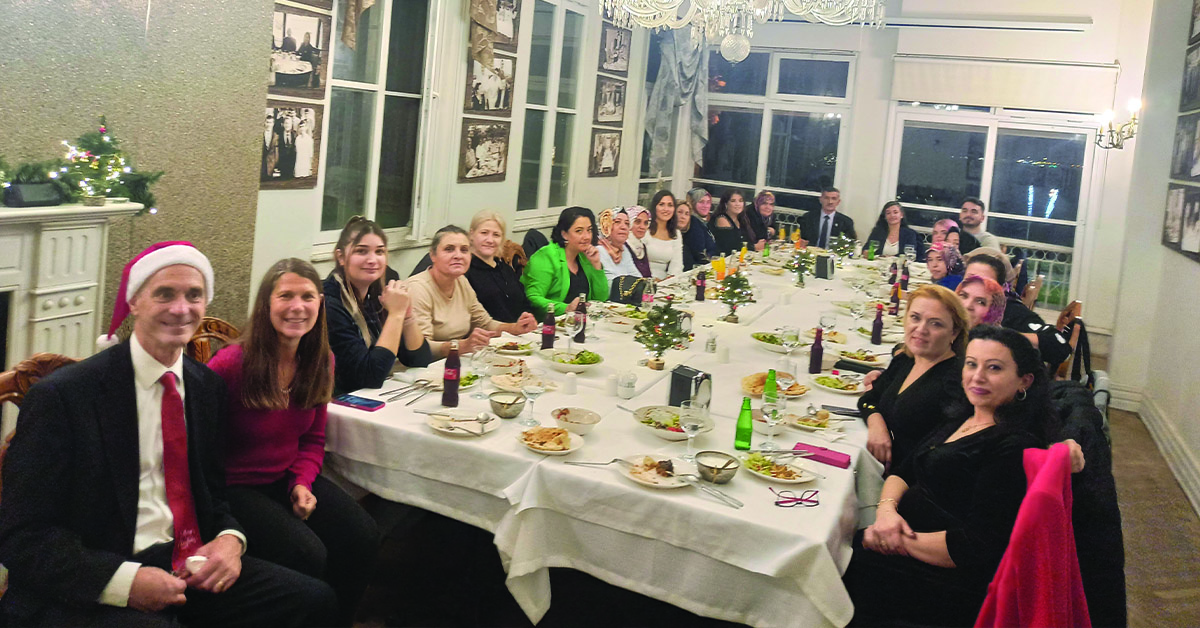 A lengthy table filled with teachers and student at the Women's Empowerment Center.