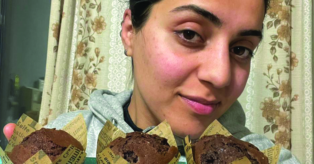 A woman showing her baked goods.