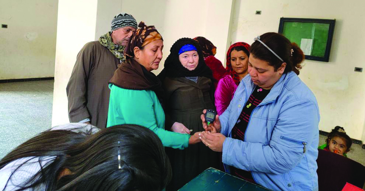 A doctor looking at Egyptian patients.