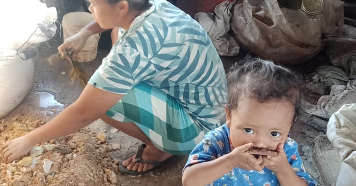 An infant and mother at a farm location.