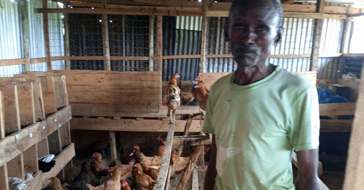 A farmer showing his chicken coop