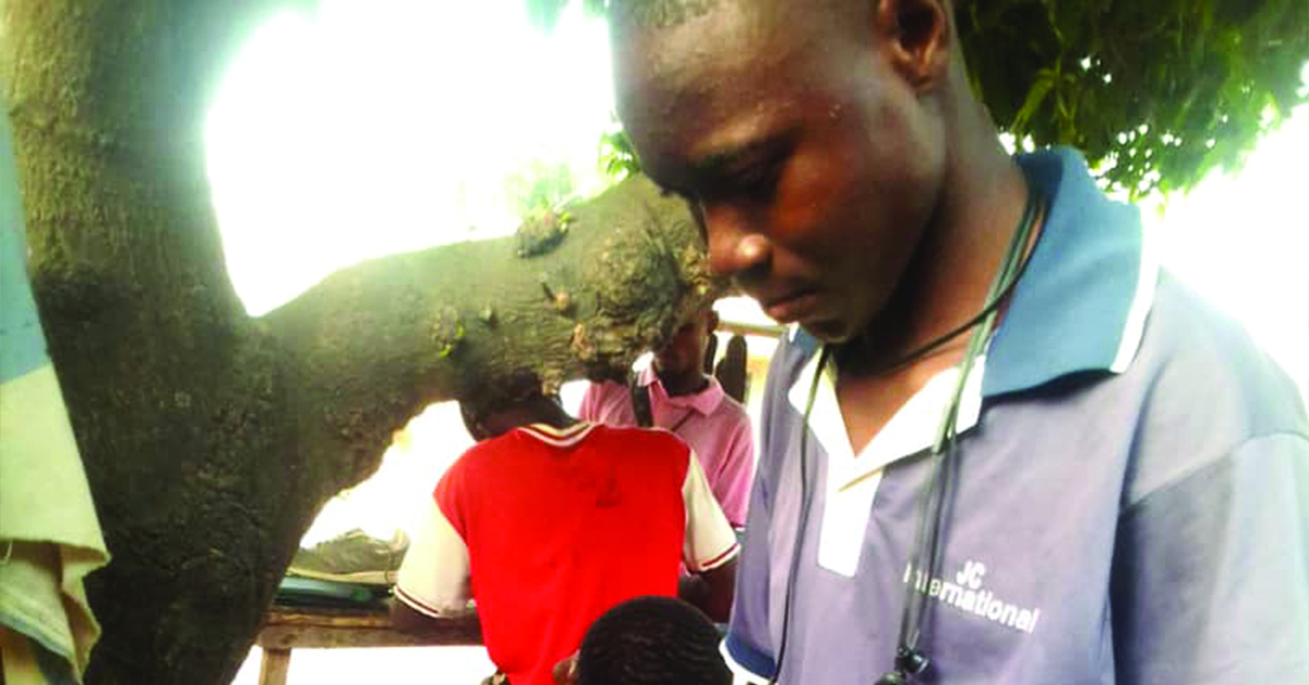 A Nigerian man working on his specialty with shoes.