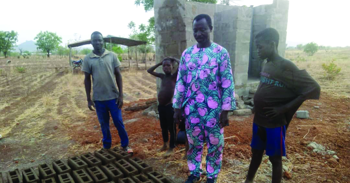Togo men building a latrine with cement.