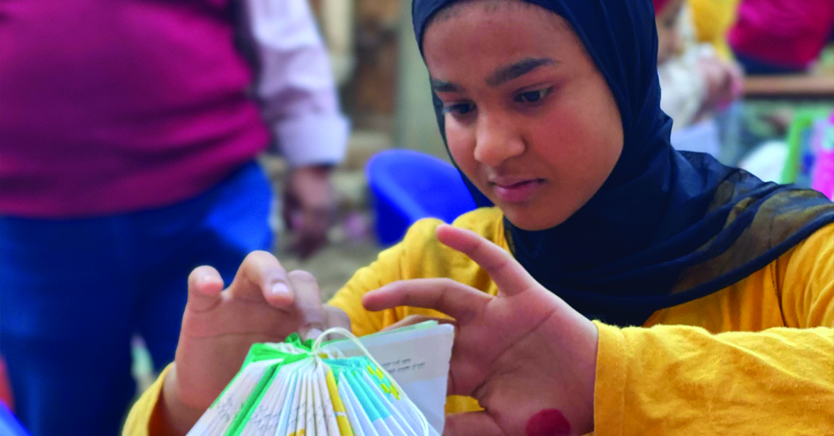 An Egyptian girl making a lantern.