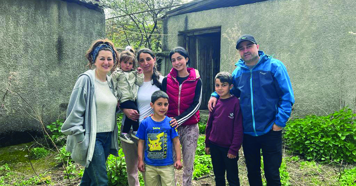 An Armenian family posing for the camera, casually.