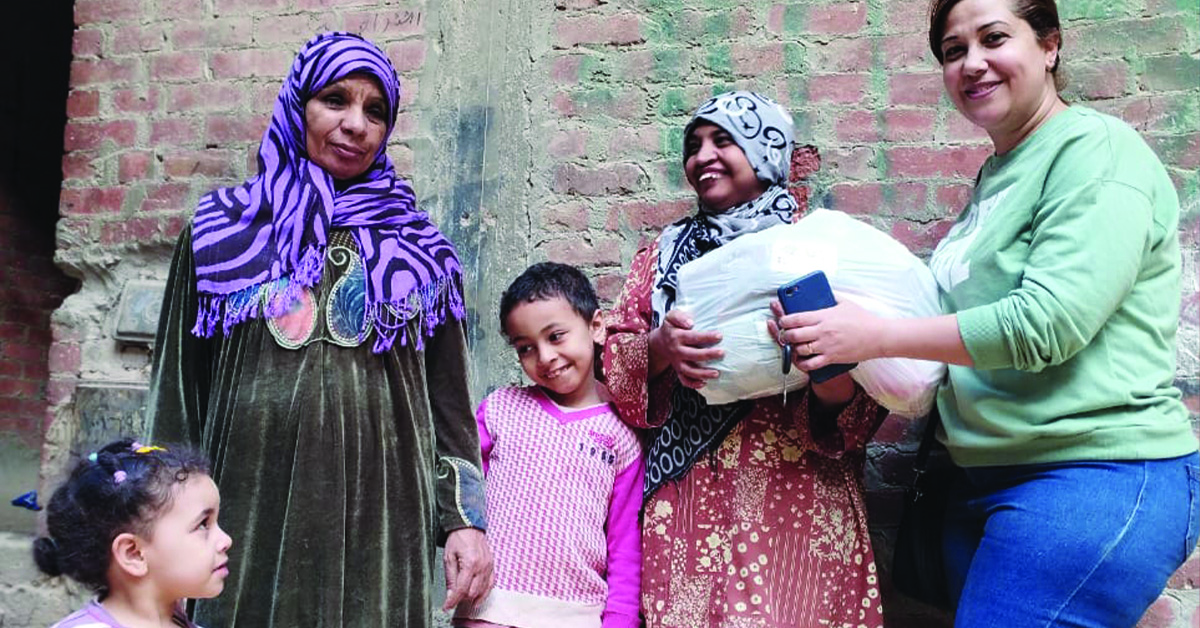 An Egyptian family with their food relief bags.
