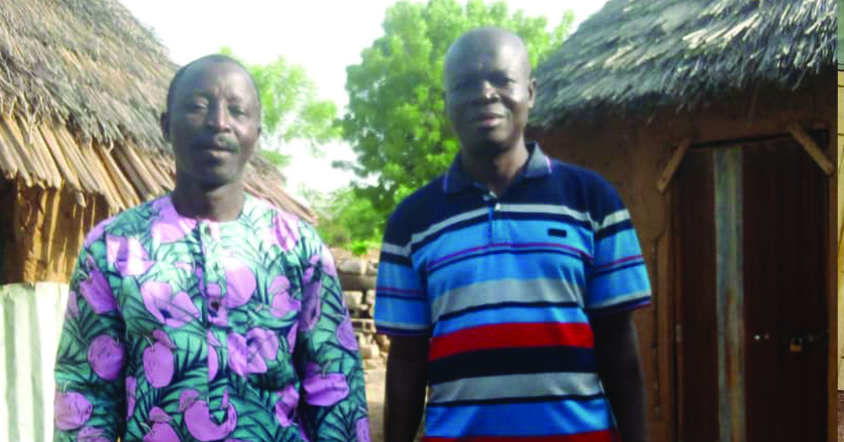 Two Togo villagers standing in their village.