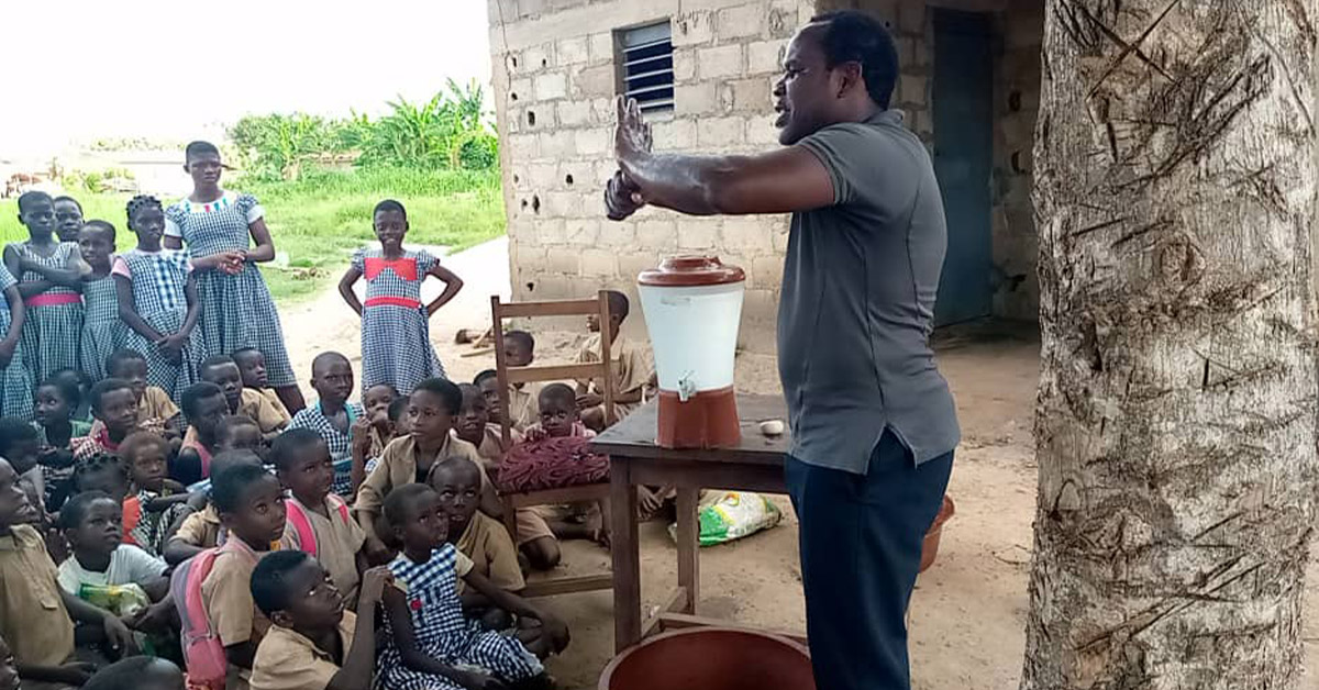 A TCD worker teaching a hand-washing lesson to children.