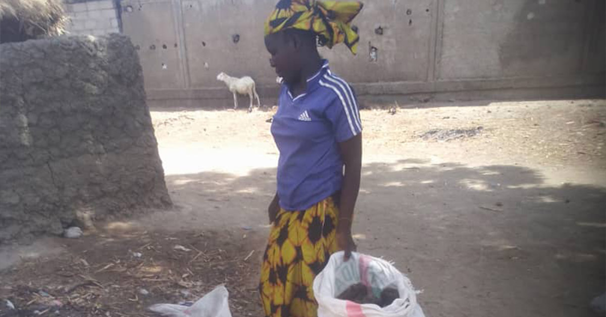 Ngassa villager with two bags of animal fertilizer