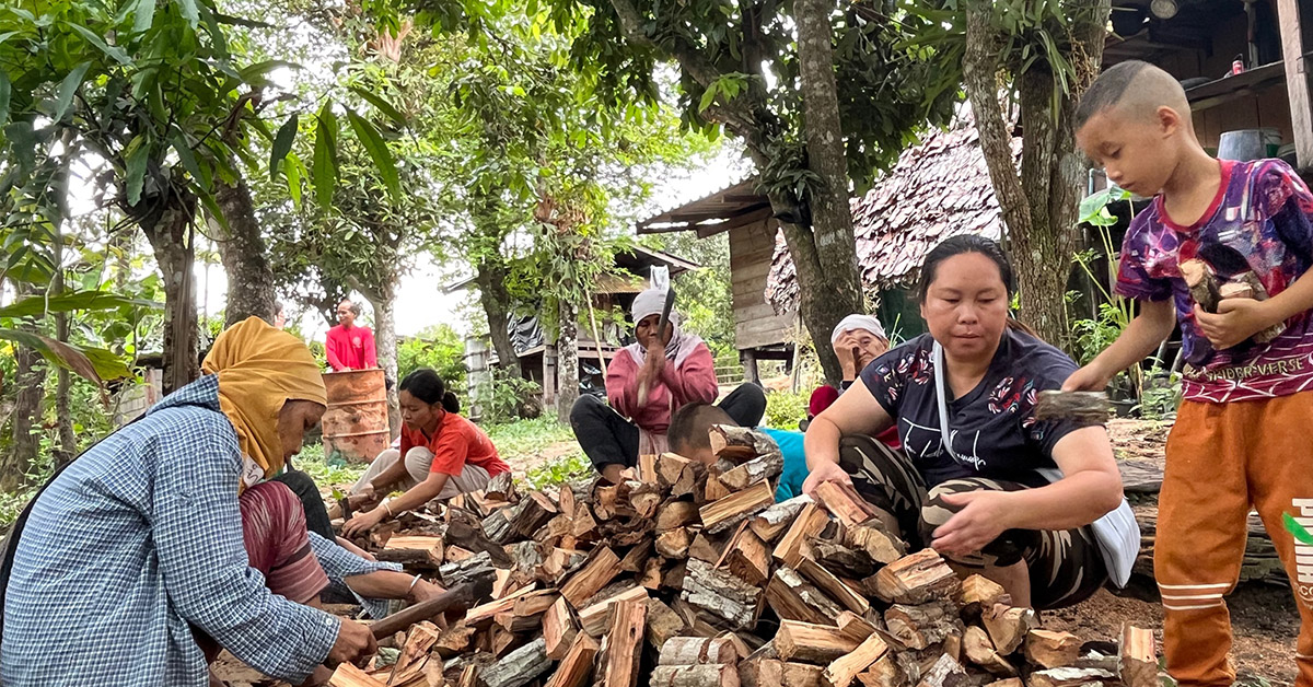 Thailand villagers cutting wood.