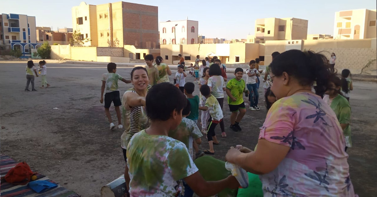 Egyptian children and teachers outdoors for sports activities.