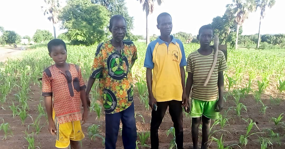 Togo villagers standing with their crops.
