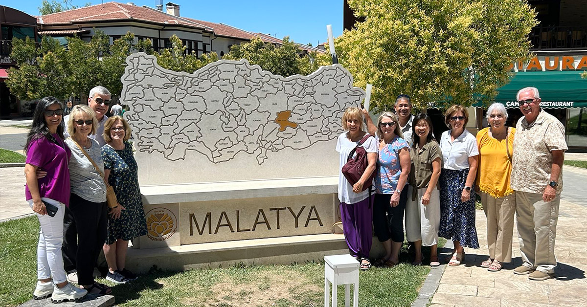The TCD team standing in front of a Malatya statue.