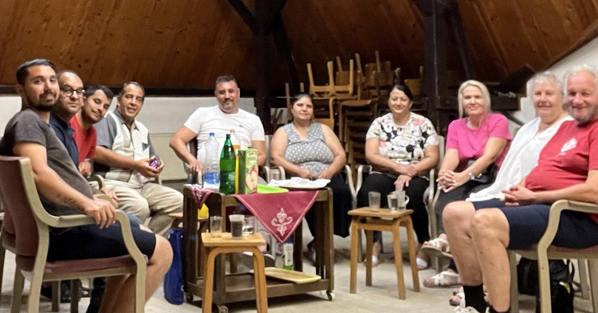 A group of Serbians in a circle and indoors.