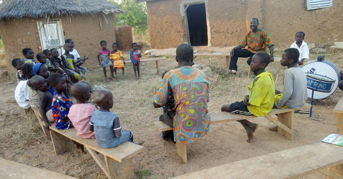 A TCD worker teaching a small group of Togo villagers.