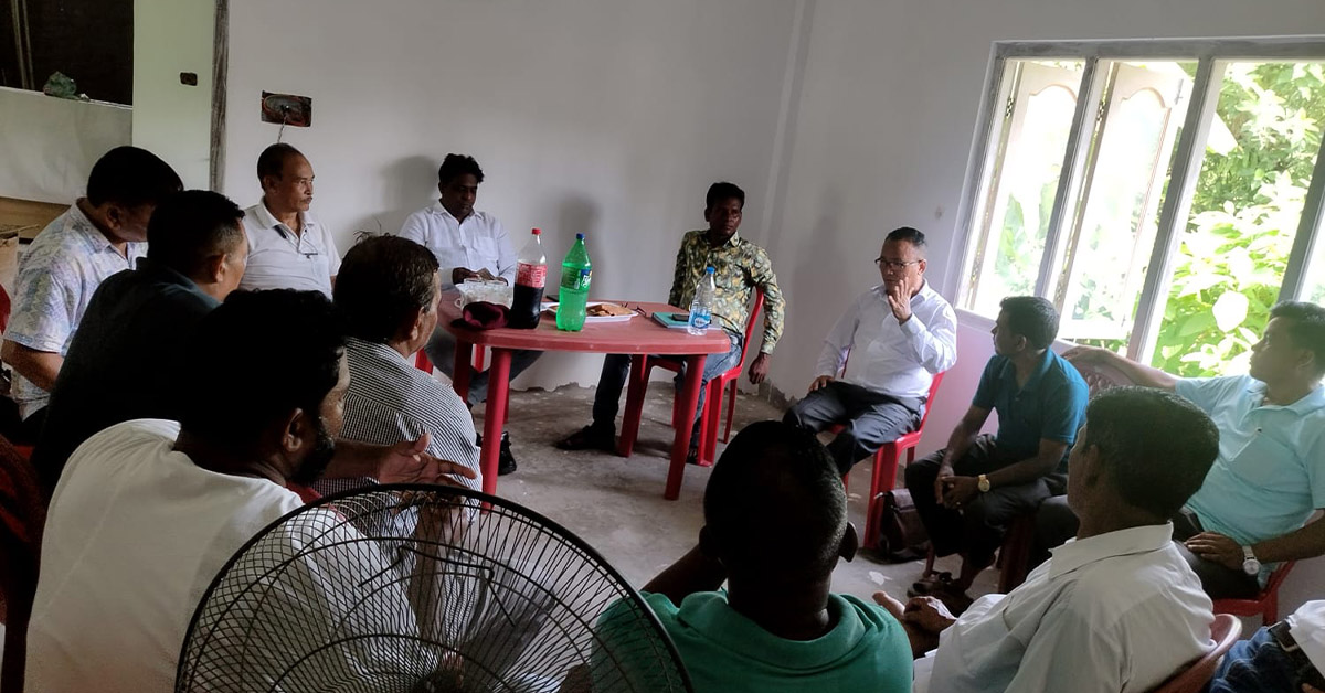 A group of men in a circle and in a discussion.