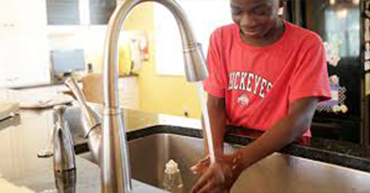 A Kenyan villager washing his hands after using the restroom.