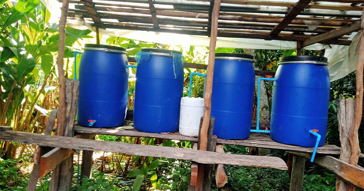 Four tall, blue containers that house filters for water.