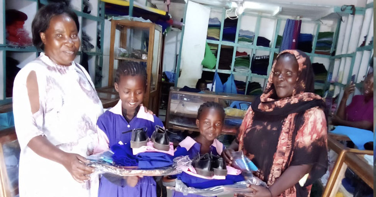Isiolo students, Esther and Winner, showing off their new uniforms.