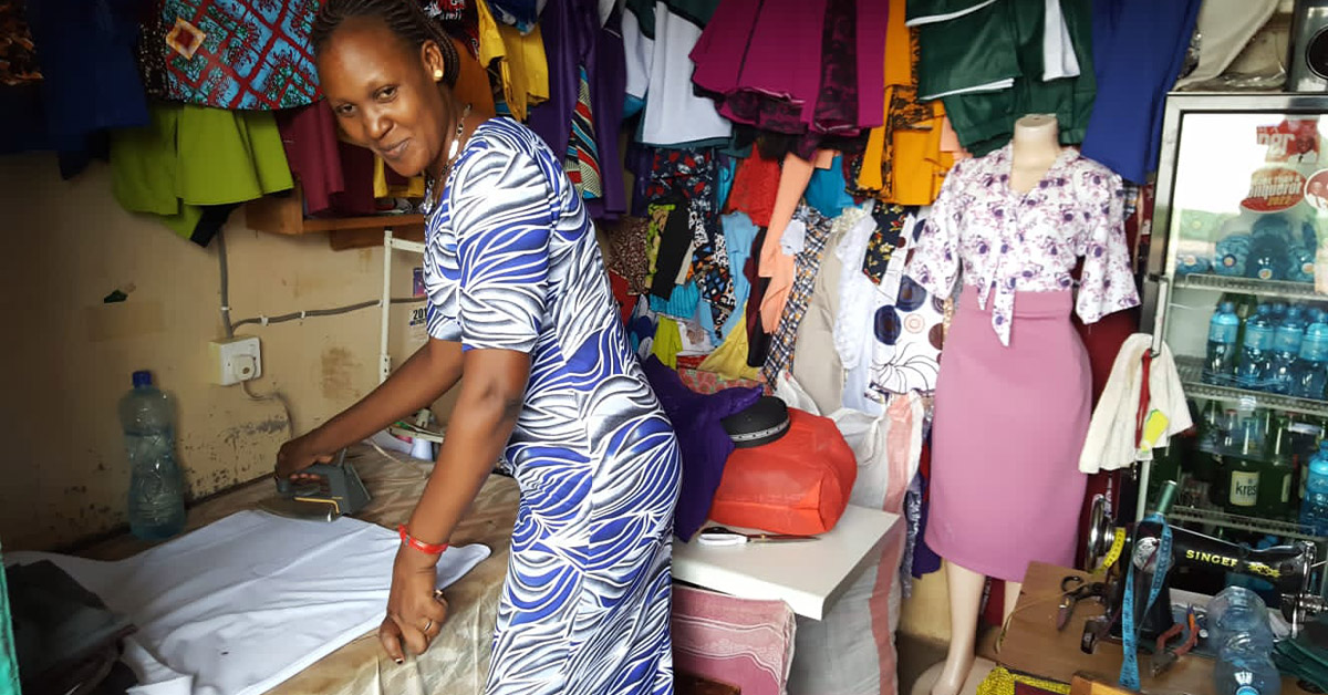 A Kenyan woman ironing a dress.