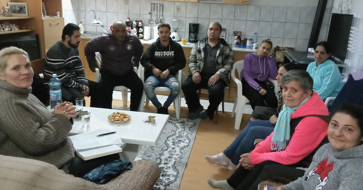 An indoor, Dorgovska Mahala TCD meeting that has middle-age to older-age citizens.