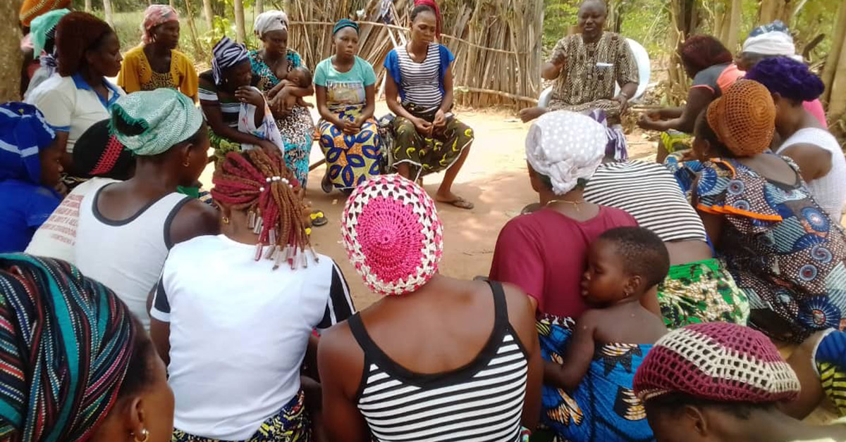 The Income Generation Group in Benin listening to a lesson in a circle.