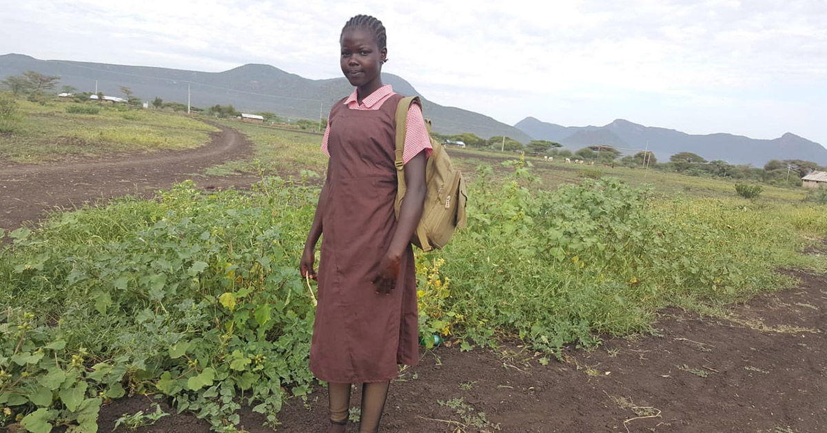 Kenyan villager, Diana, out in the gardens.