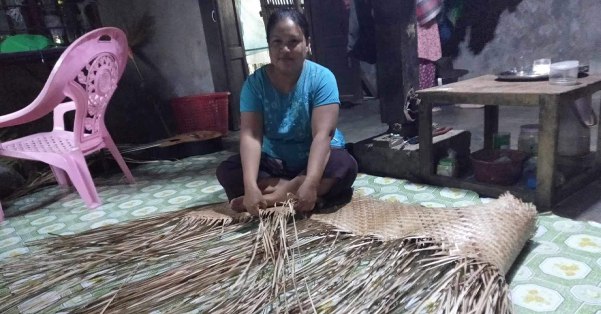 A Myanmar woman working with straw as income generation.