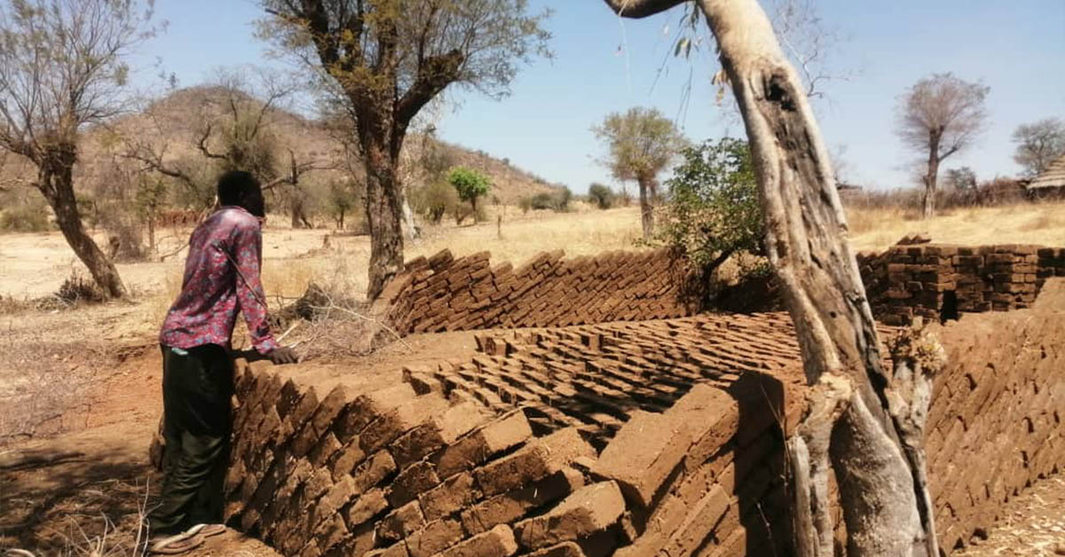 A partly-erected, rectangular, mud building at Sawaya Village.