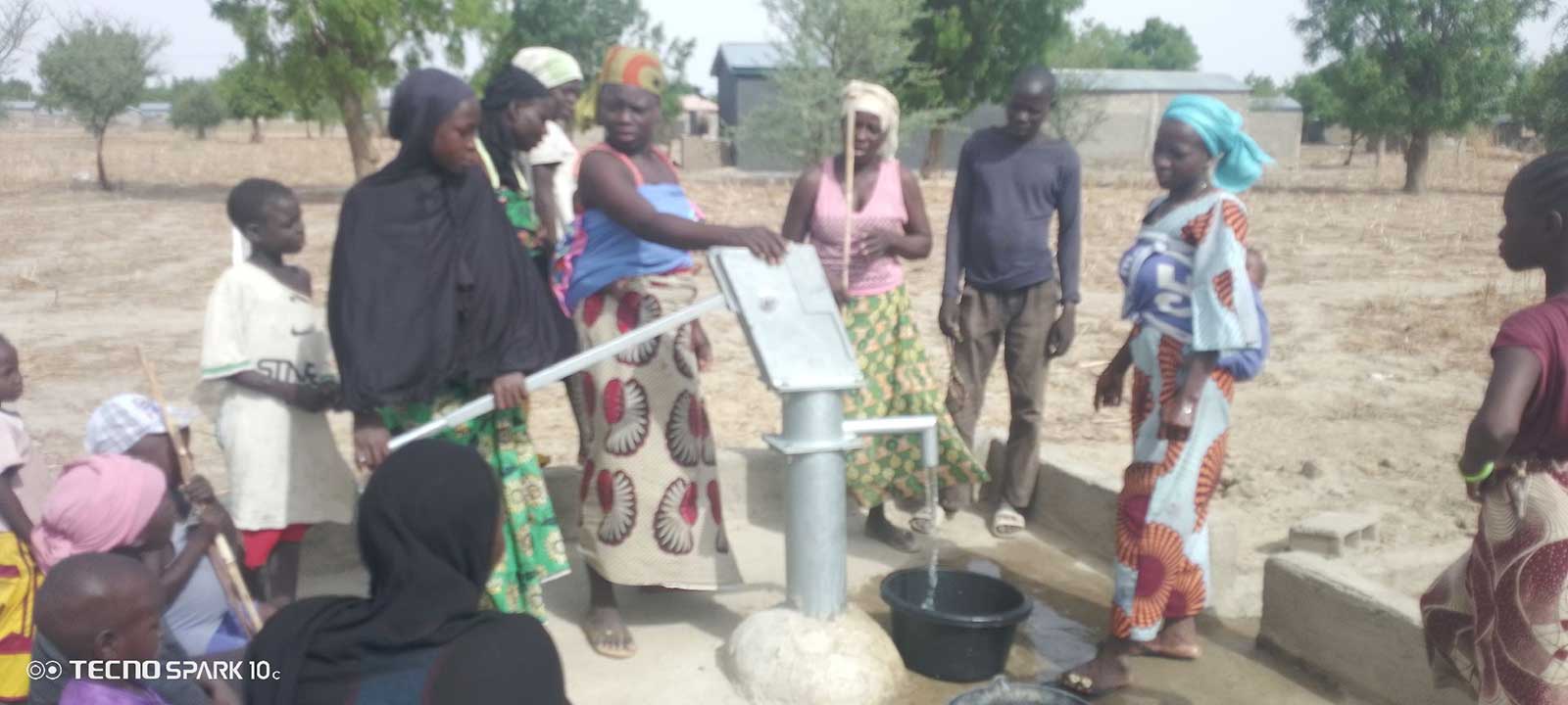 A group of Ngassa villagers pumping water.