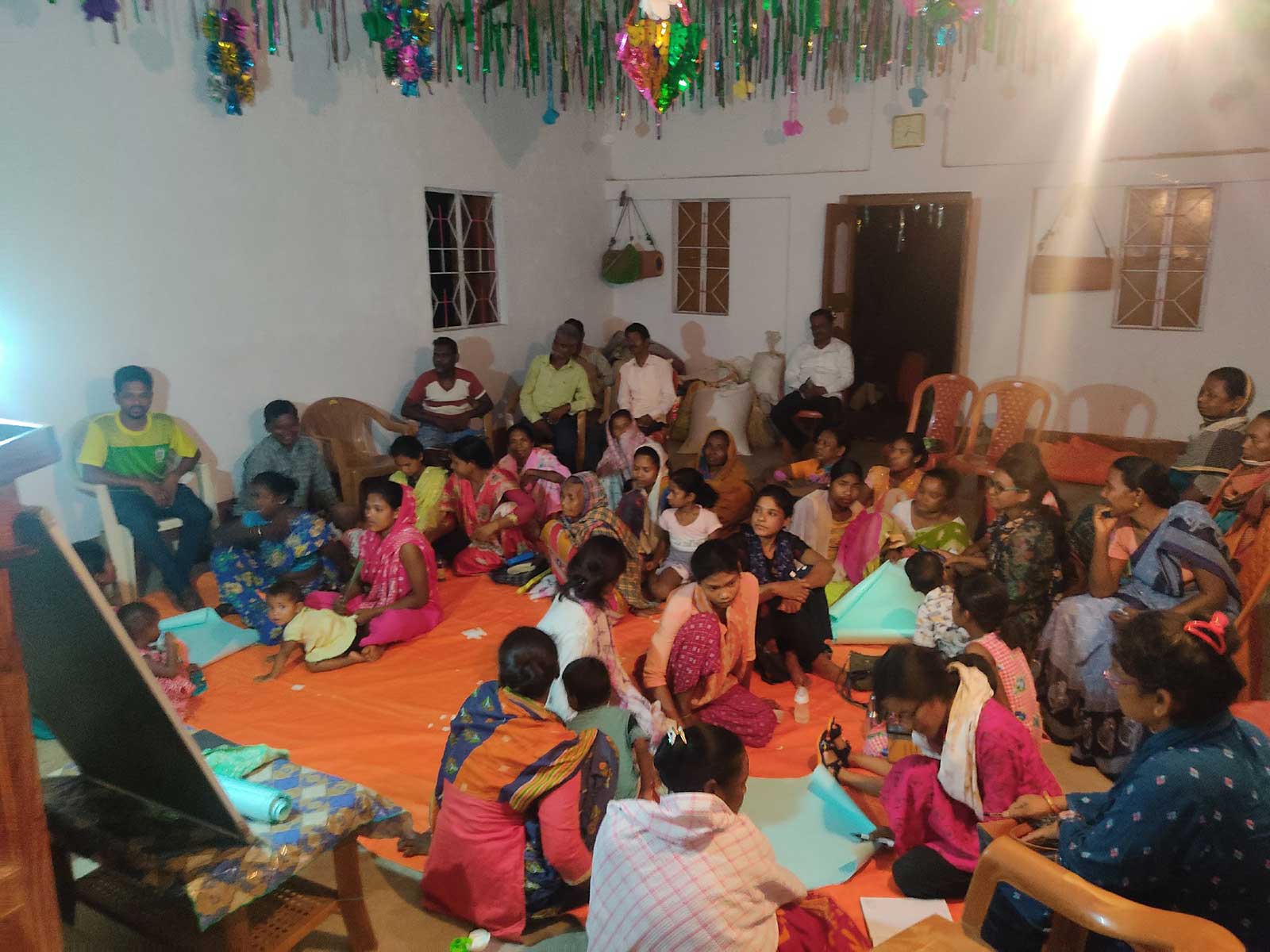 A large amount of Shri Ambra villagers at a TCD Training session indoors.