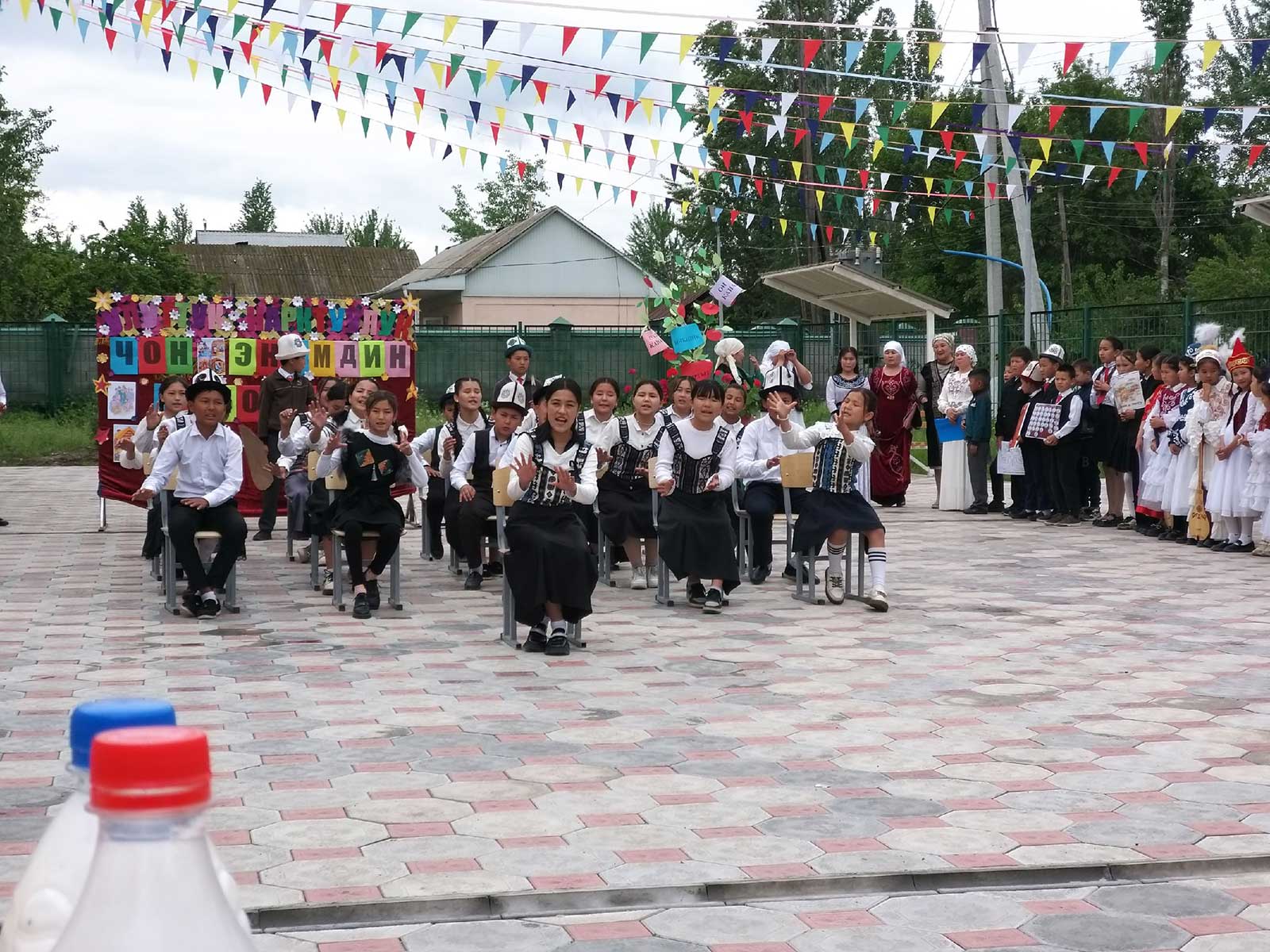 Kyrgystan children doing an outdoor performance for school.