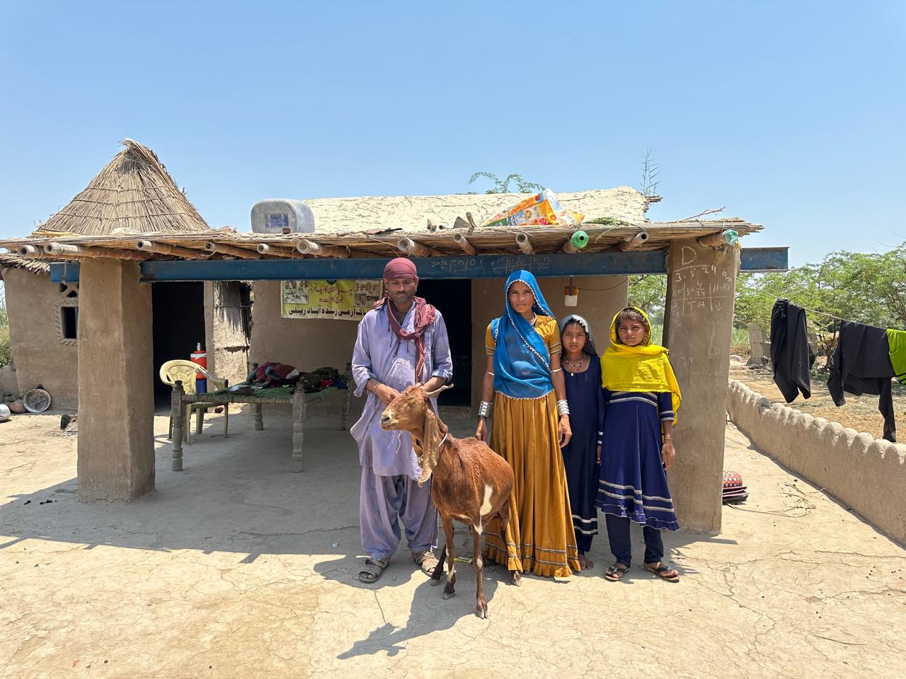 A family of four with their new and acquired goat.