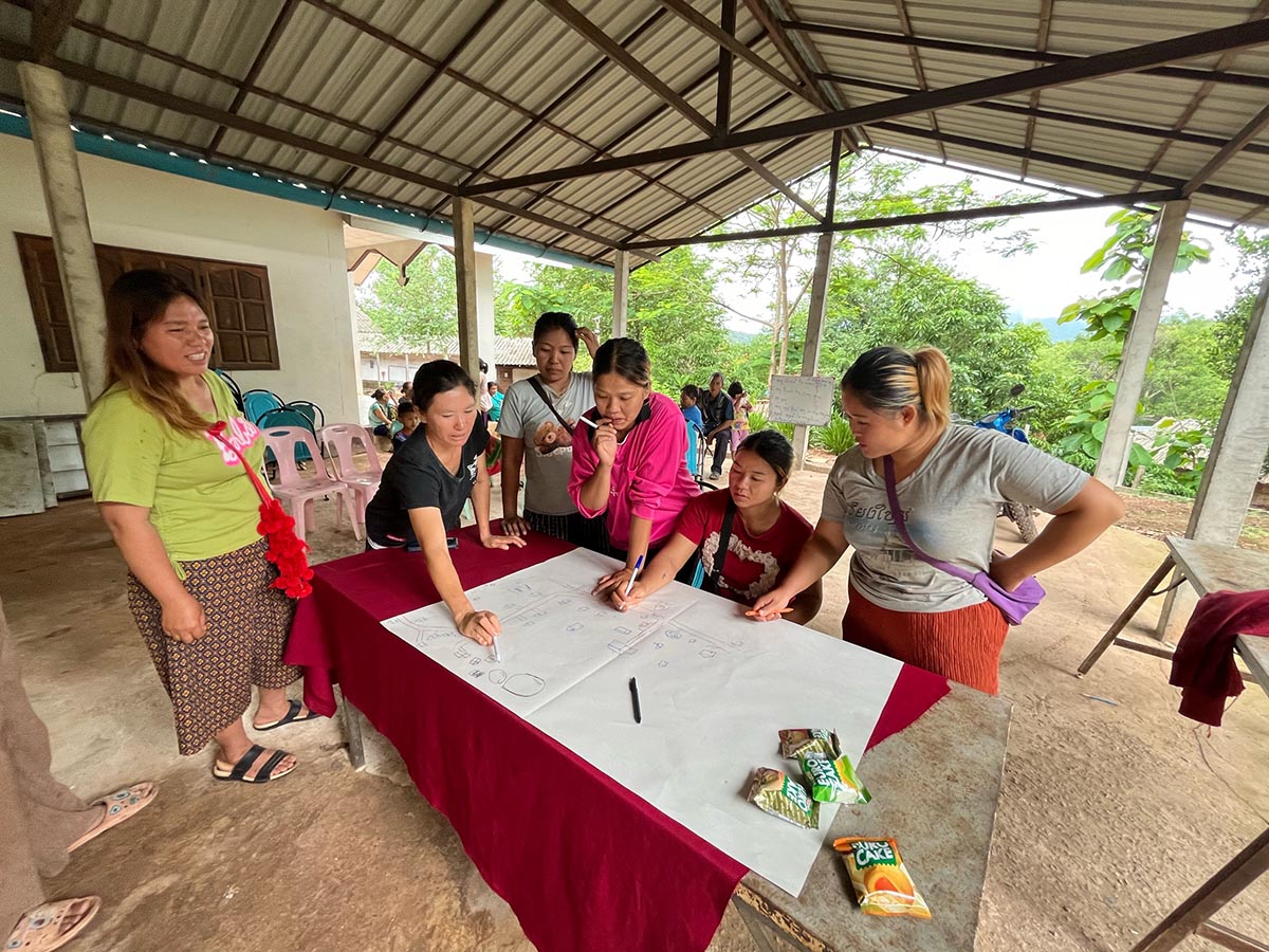 The Thailand community drawing up a large map and calendar for the year.